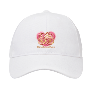 p cap r234 White peaked cap with the pink and gold Endurance Diaries heart logo.